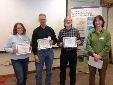 Jane St. Denis, Ken Guertin, and Mike Sperry receiving
                  their Certificates of Appreciation from Susan Thomas (far right)
                  for volunteering 5-9 years as monitors with the Blackstone River
                  Coalition's Watershed-wide Volunteer Water Quality Monitoring Program.