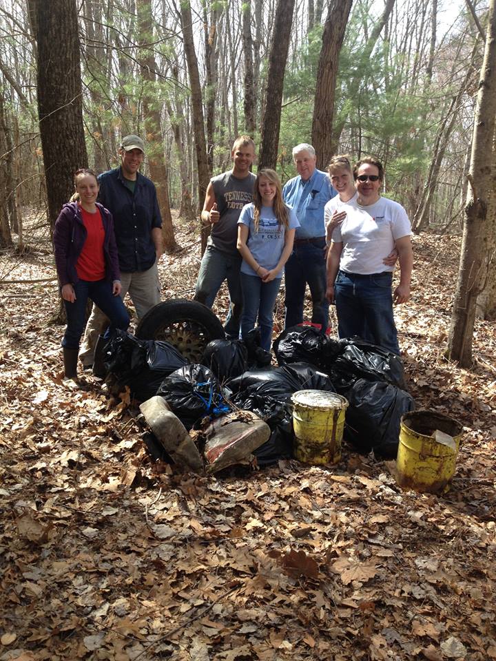 2015 Earth Day volunteers at Plummers Landing with pile of trash.