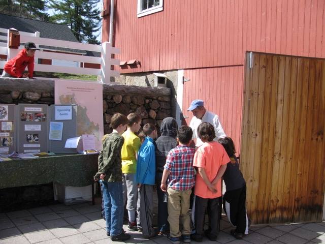 kids gathered around watershed model demonstrated by Peter Coffin