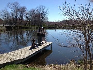 Young girl with mother fishing.