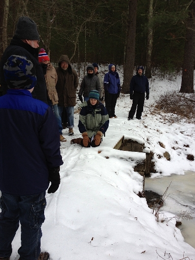 Guide Susan Thomas and group discussing track patterns in the snow