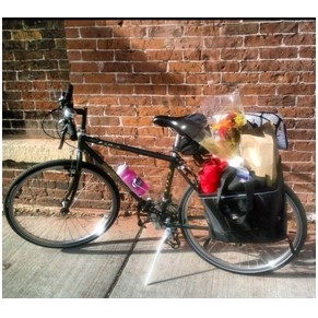 bicycle with groceries in cargo carrier.