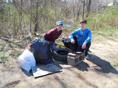 Two young volunteers with a pile of trash