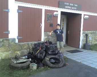 A volunteer with trash haul from 2014 EarthDay Cleanup.