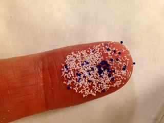 microbeads on the tip of a finger