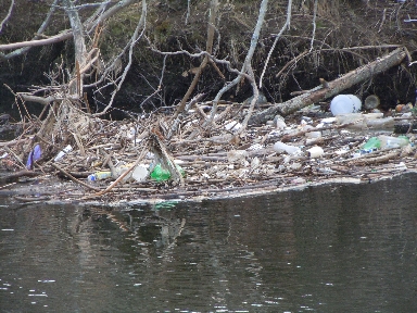 a raft of trash caught up in the Blackstone River