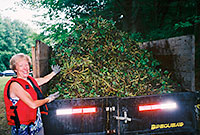 Dona Neely showing off a truckload of water chestnuts pulled out of Rice City Pond